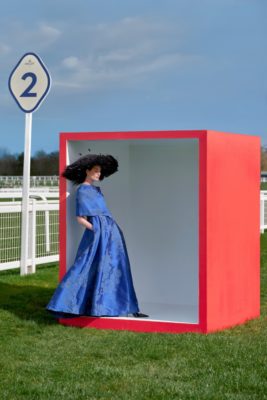 Woman in blue dress stood in red box