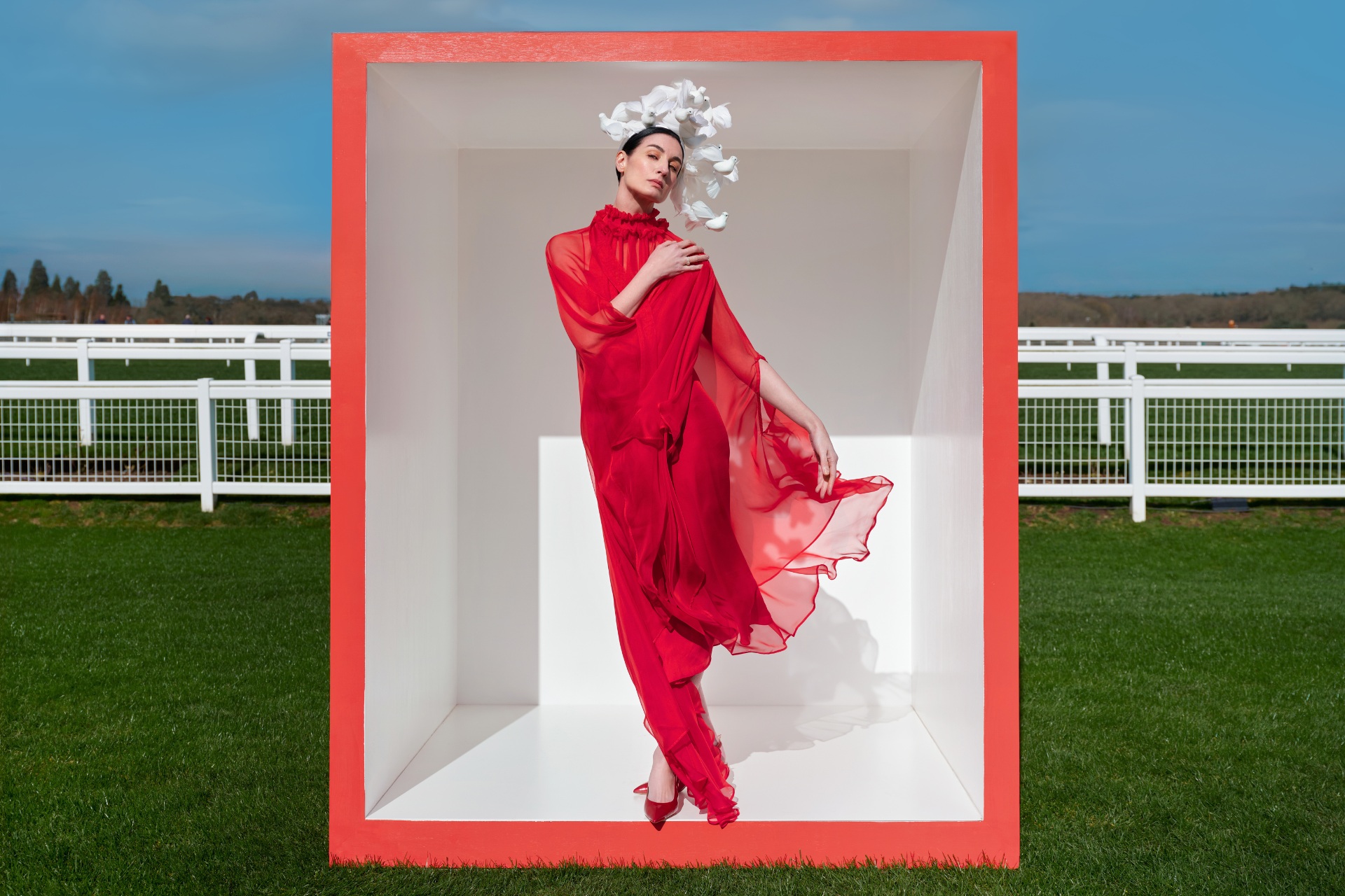 Woman wearing red dress and white hat | Royal Ascot Handbook 2026
