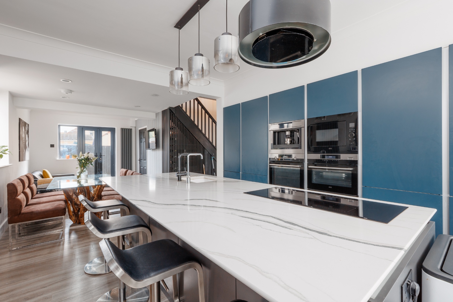 Blue wall kitchen with marble counters