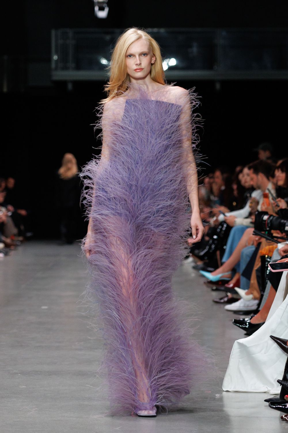 Woman wearing purple feathery dress by Stella McCartney x FEVVERS