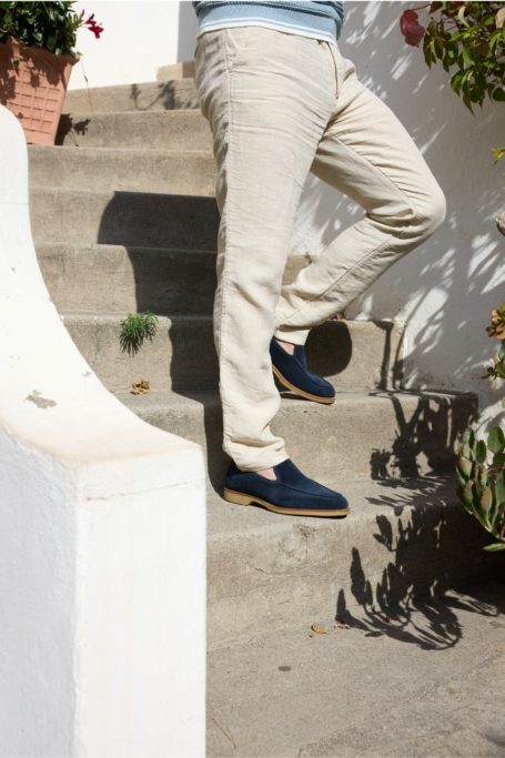 Man walking down stairs in blue loafers