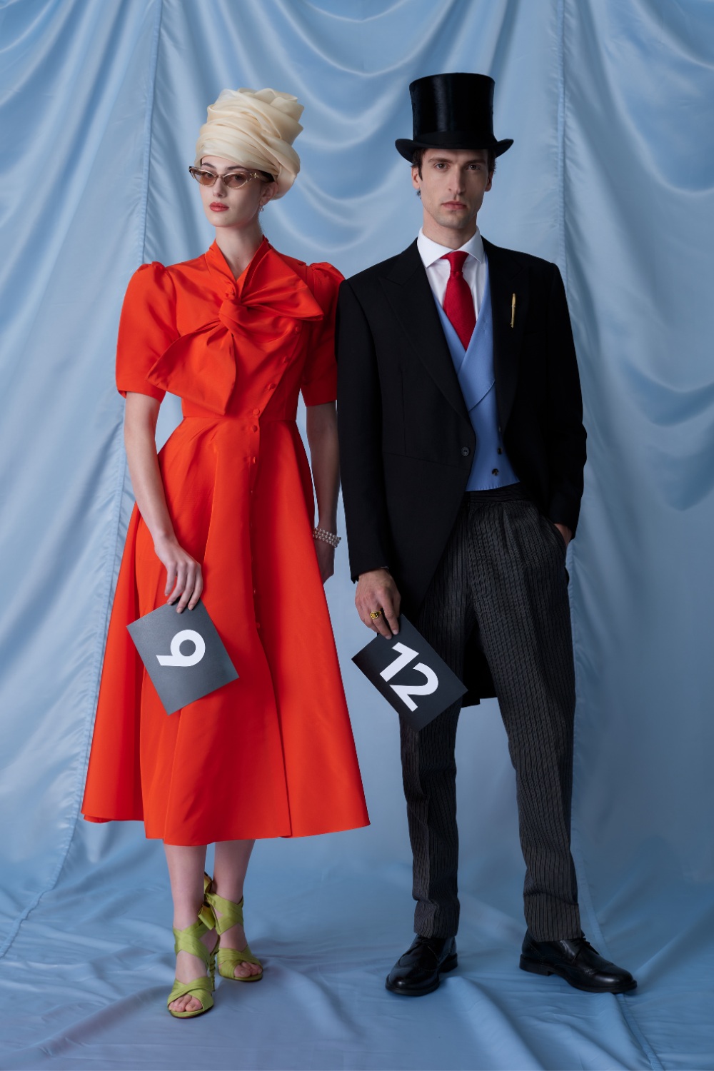 Woman in red dress and man in suit and top hat