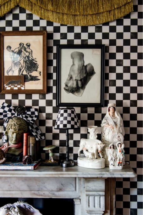 Mantel with check wallpaper behind it by British wallpaper brand Flora Black