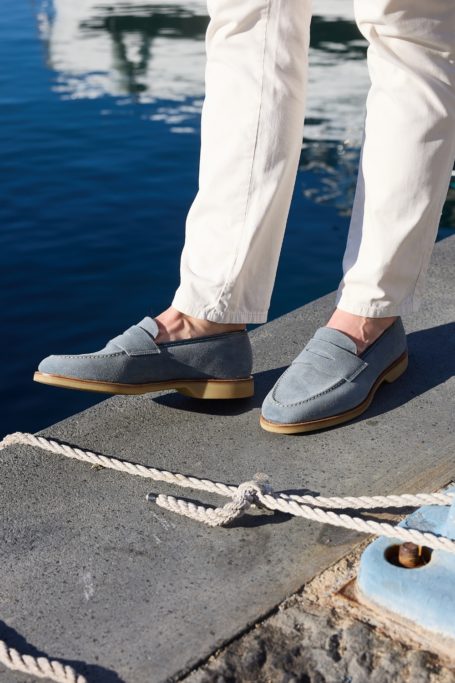 Person wearing blue suede loafers from Crockett & Jones SS26