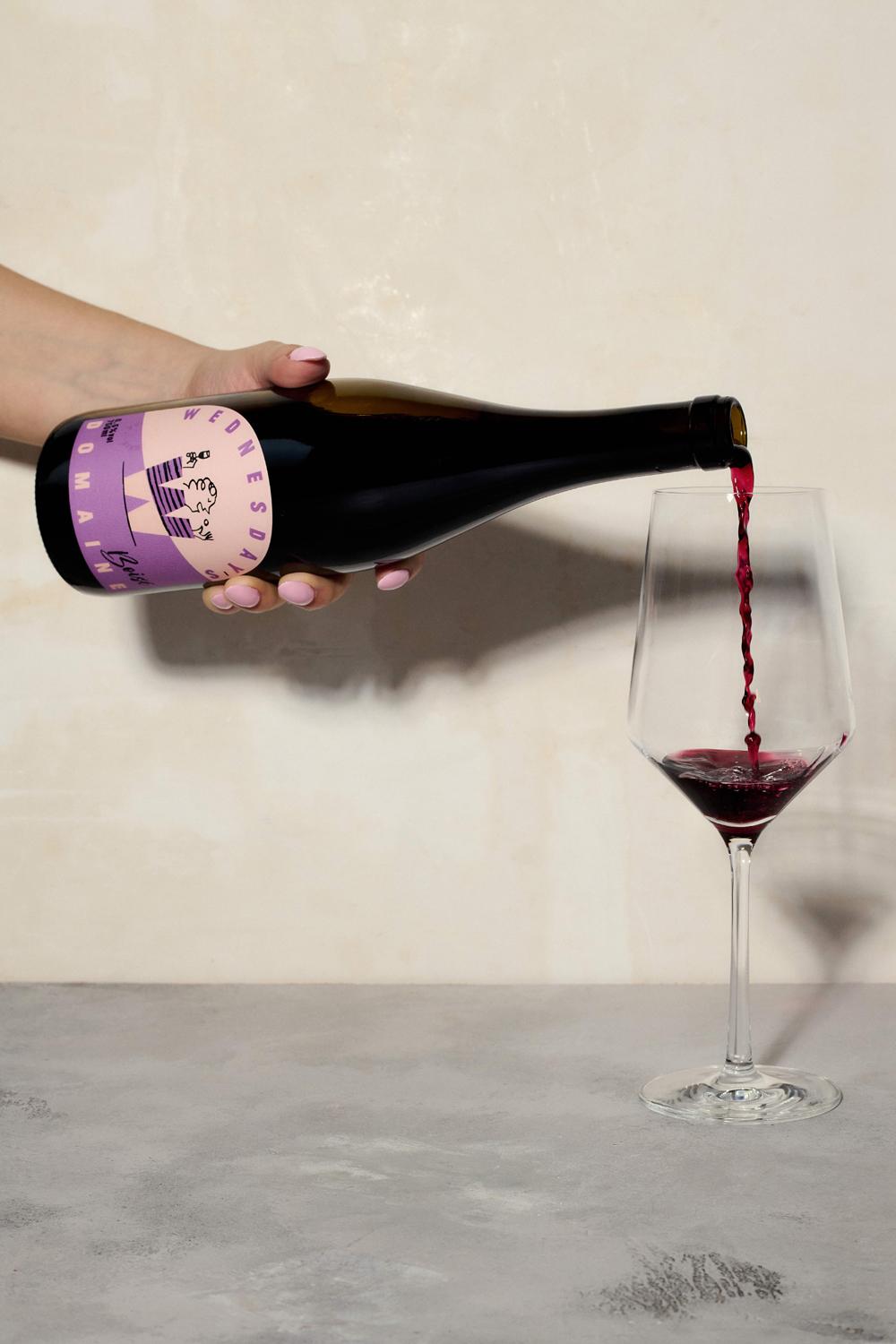 A glass of red wine being poured