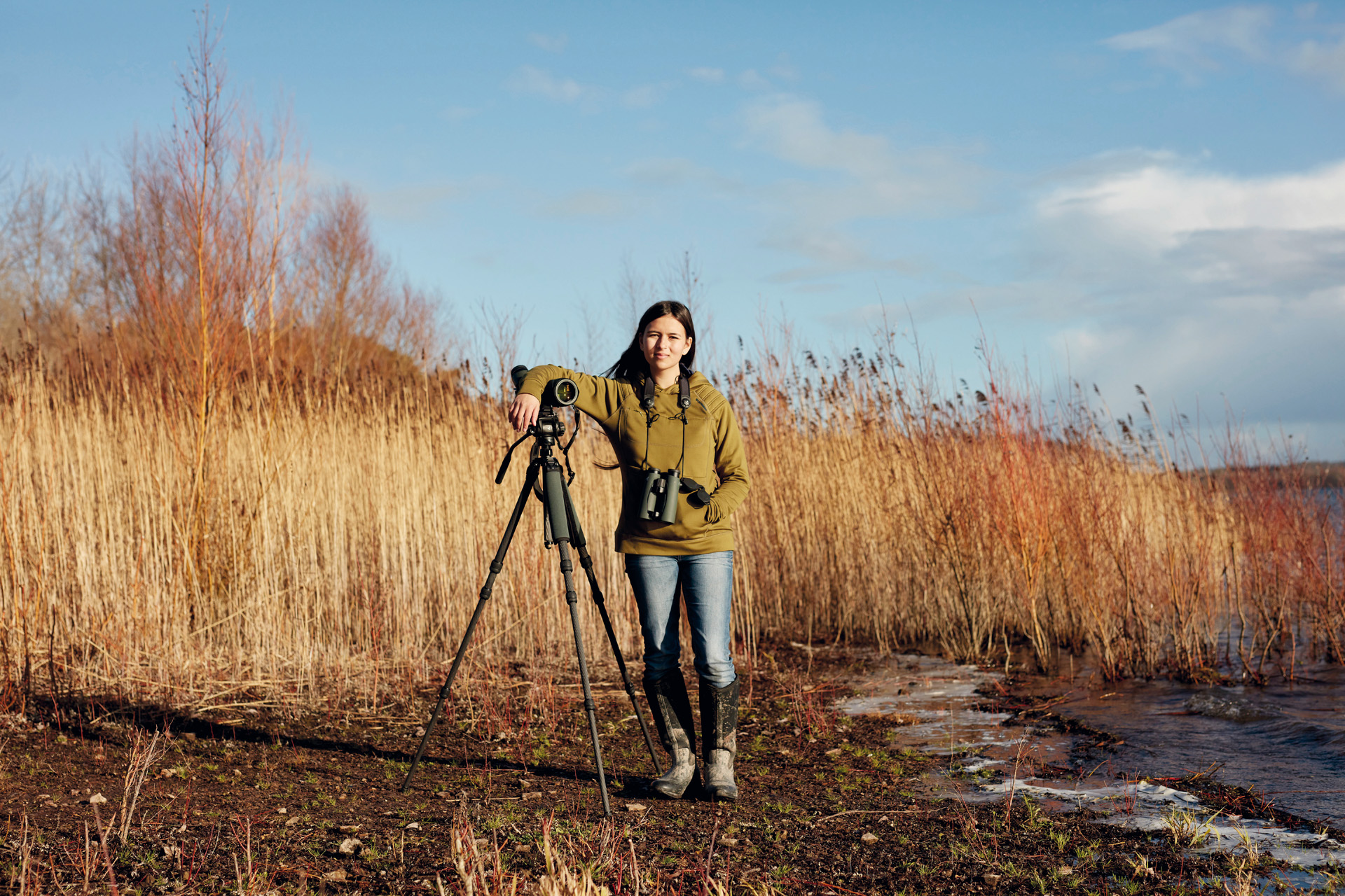 Dr Mya-Rose Craig with a camera and binoculars