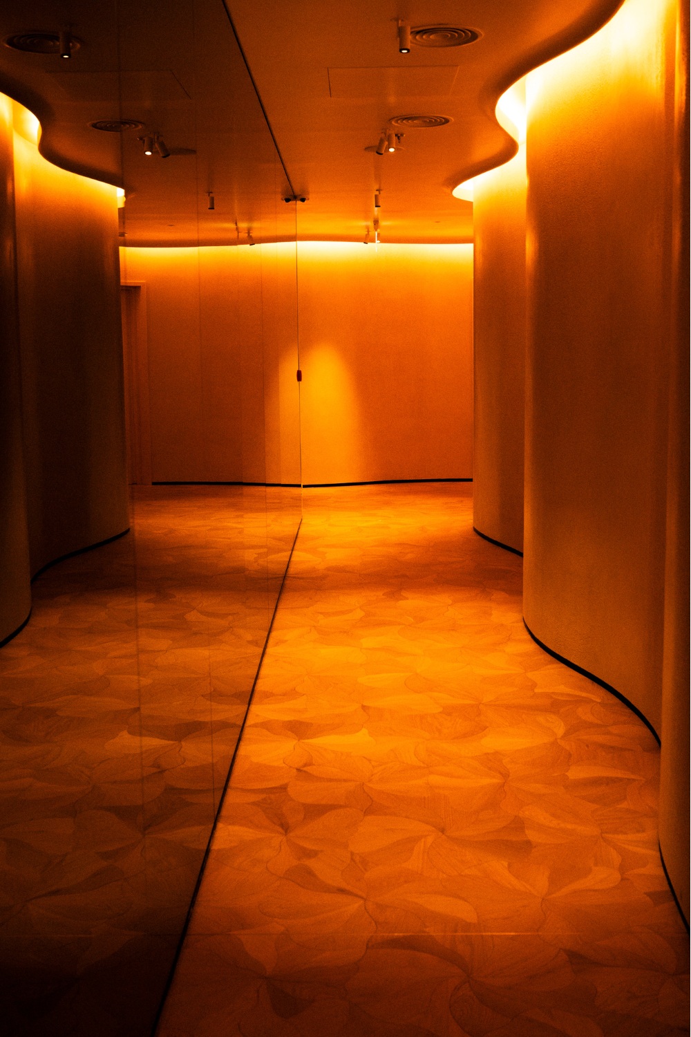 Gold-lit hallway with wavy walls