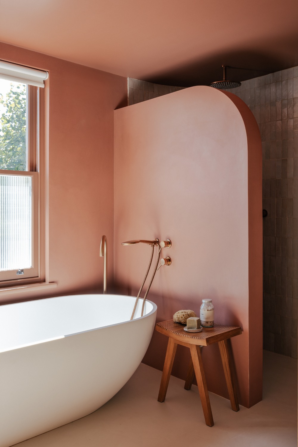 Pink bathroom with white tub