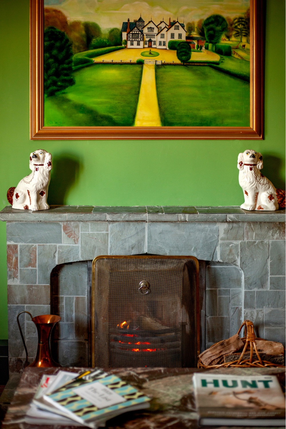 Stone fireplace with green wall above, design for 18th century gate lodge by Annie-Rose Chantler