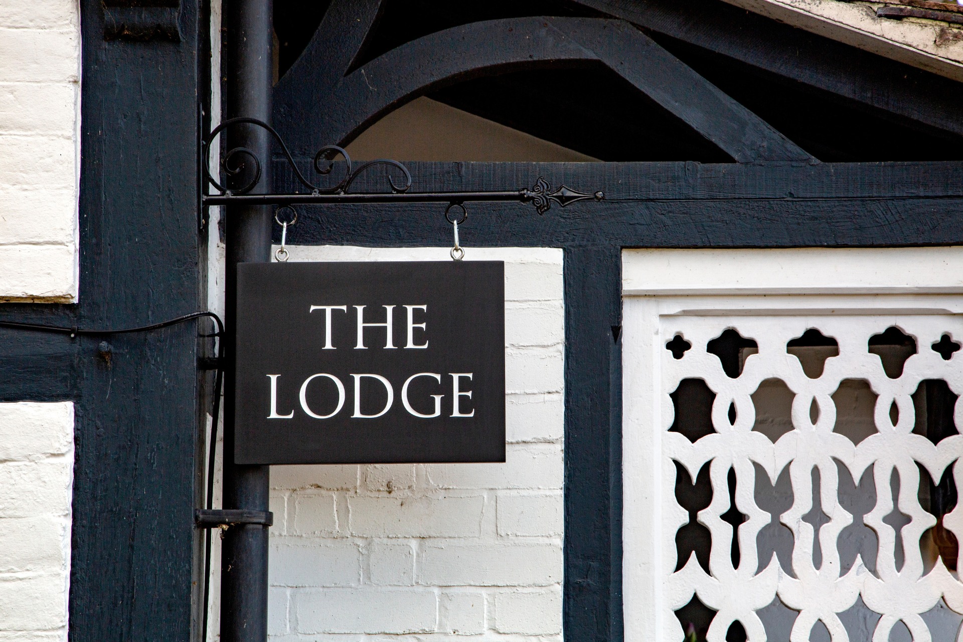 The Lodge sign in front of house