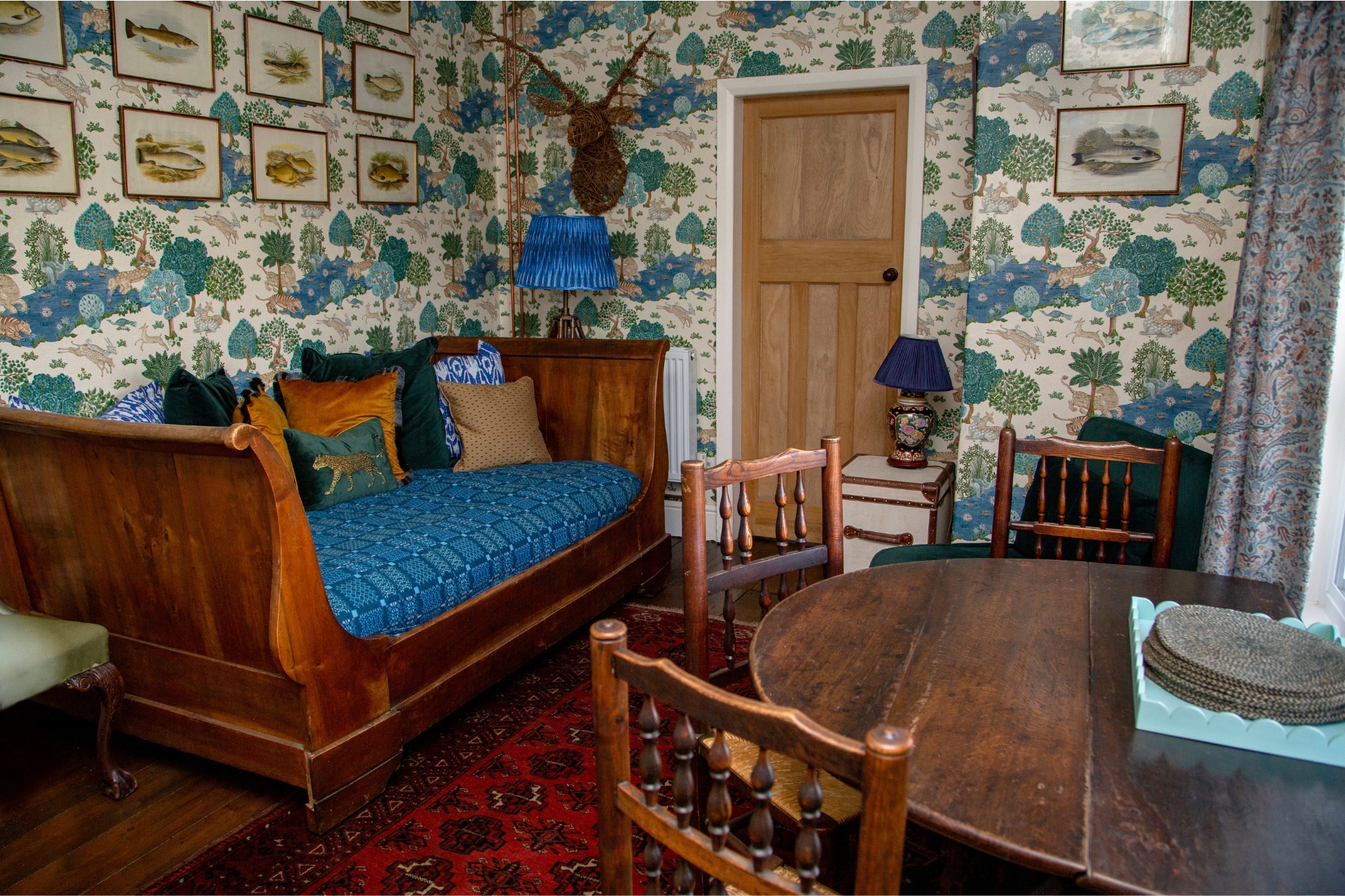 Dining room with wooden table and blue wallpapered walls