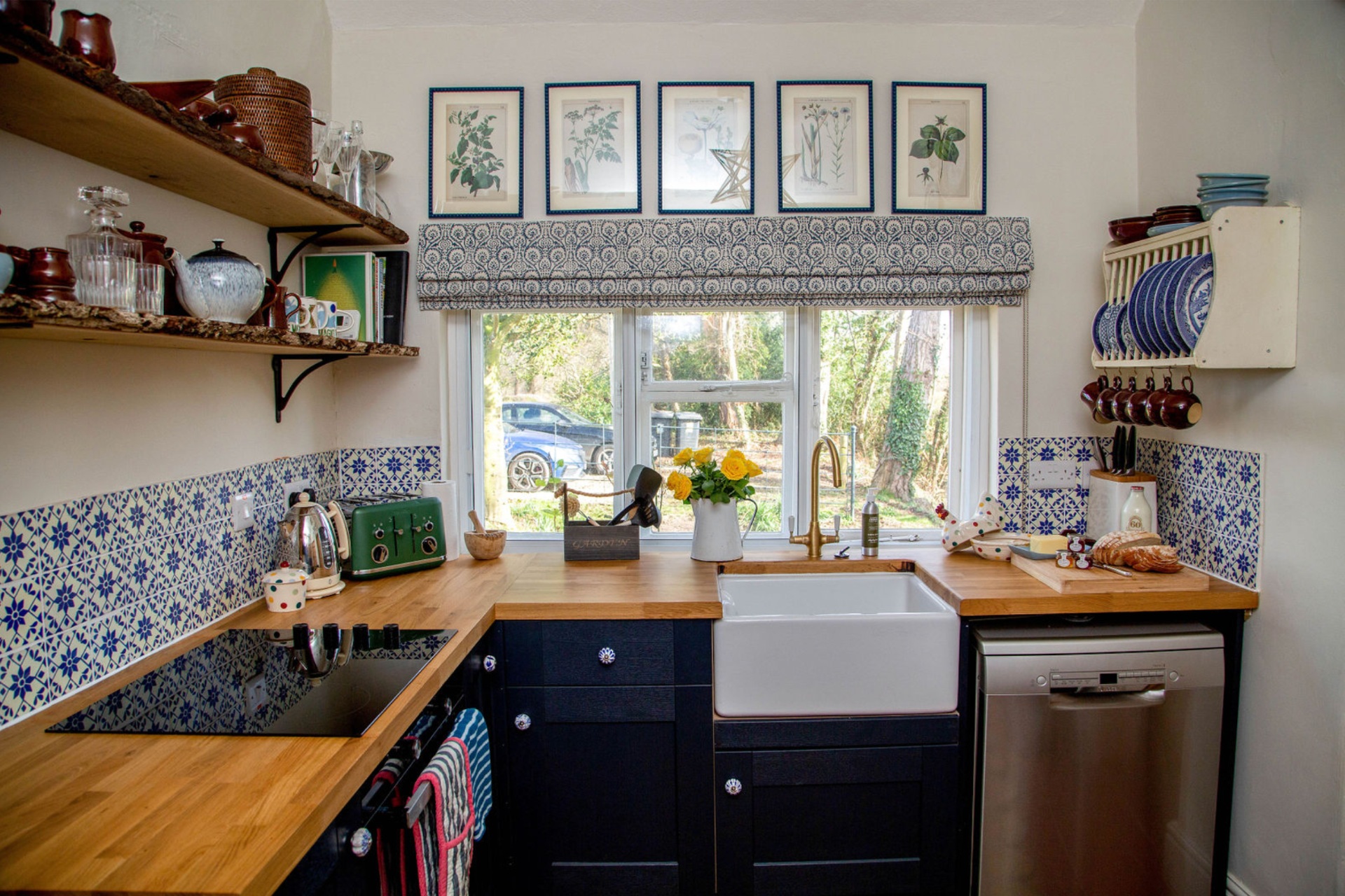 Countryside kitchen with tiled wall, wooden counters and deep porcelain sink