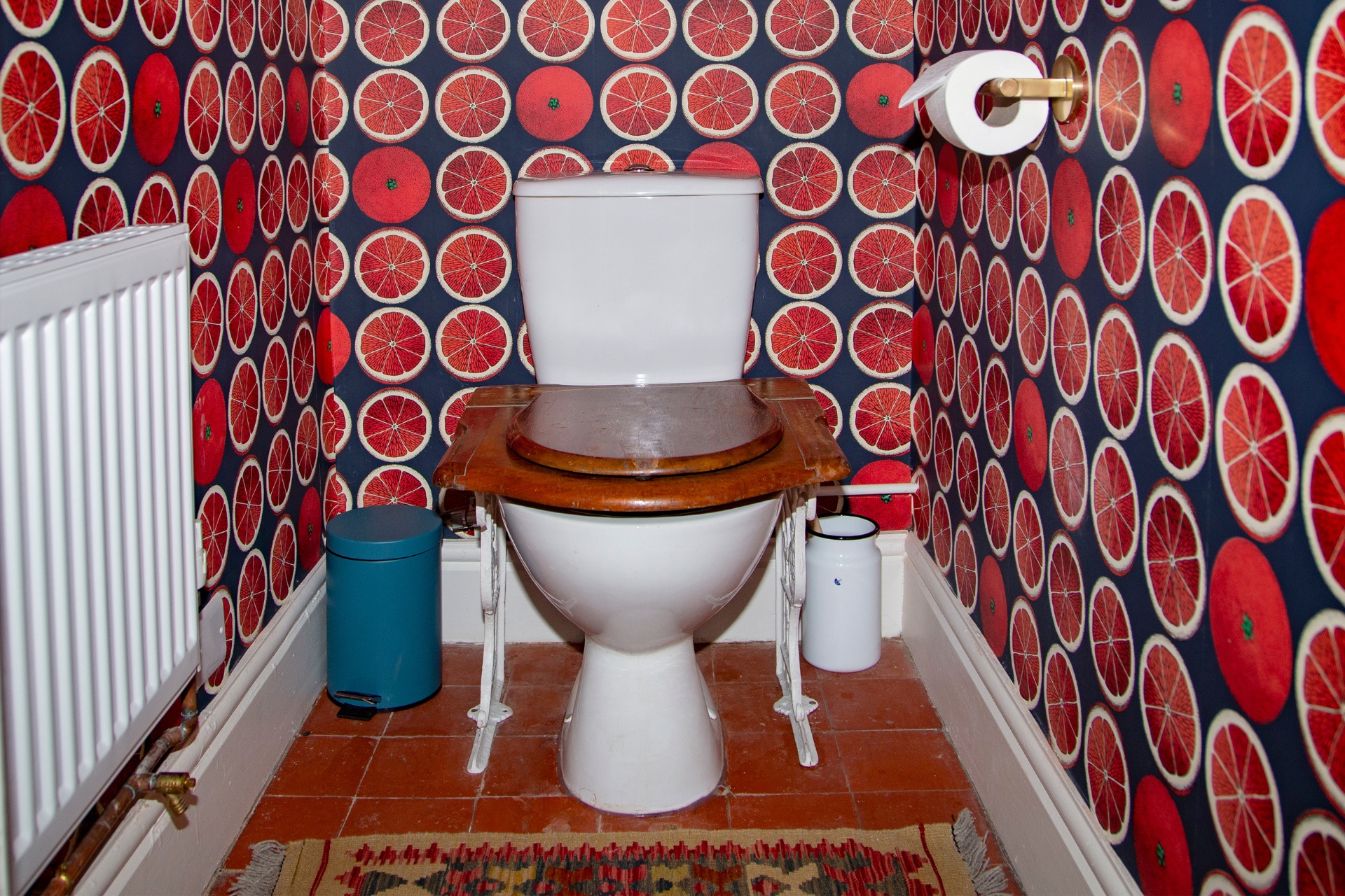 Loo with toilet and orange wallpaper