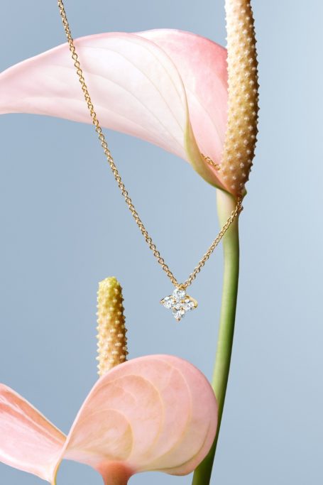 Necklace draped over flowers
