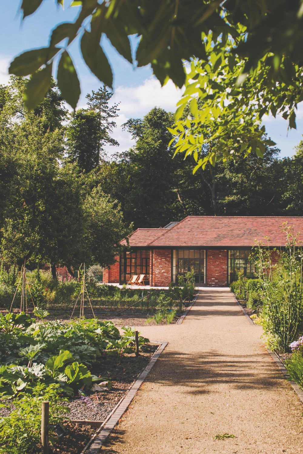 Red building surrounded by kitchen garden