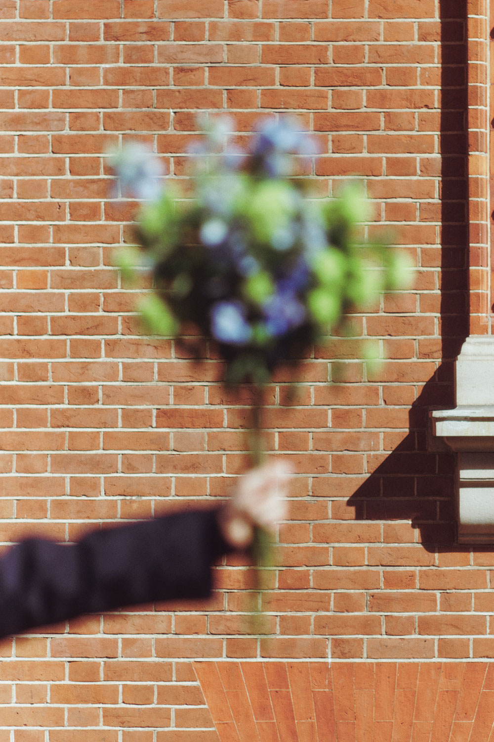 Hand holding up a bouquet of flowers