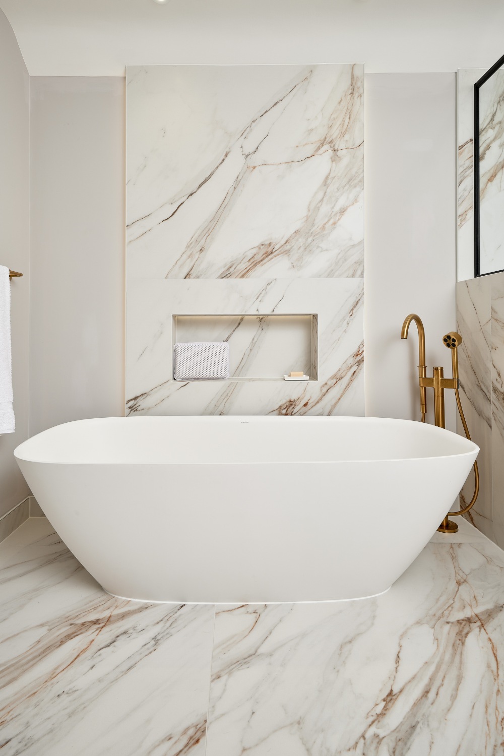 Freestanding bath in marble bathroom