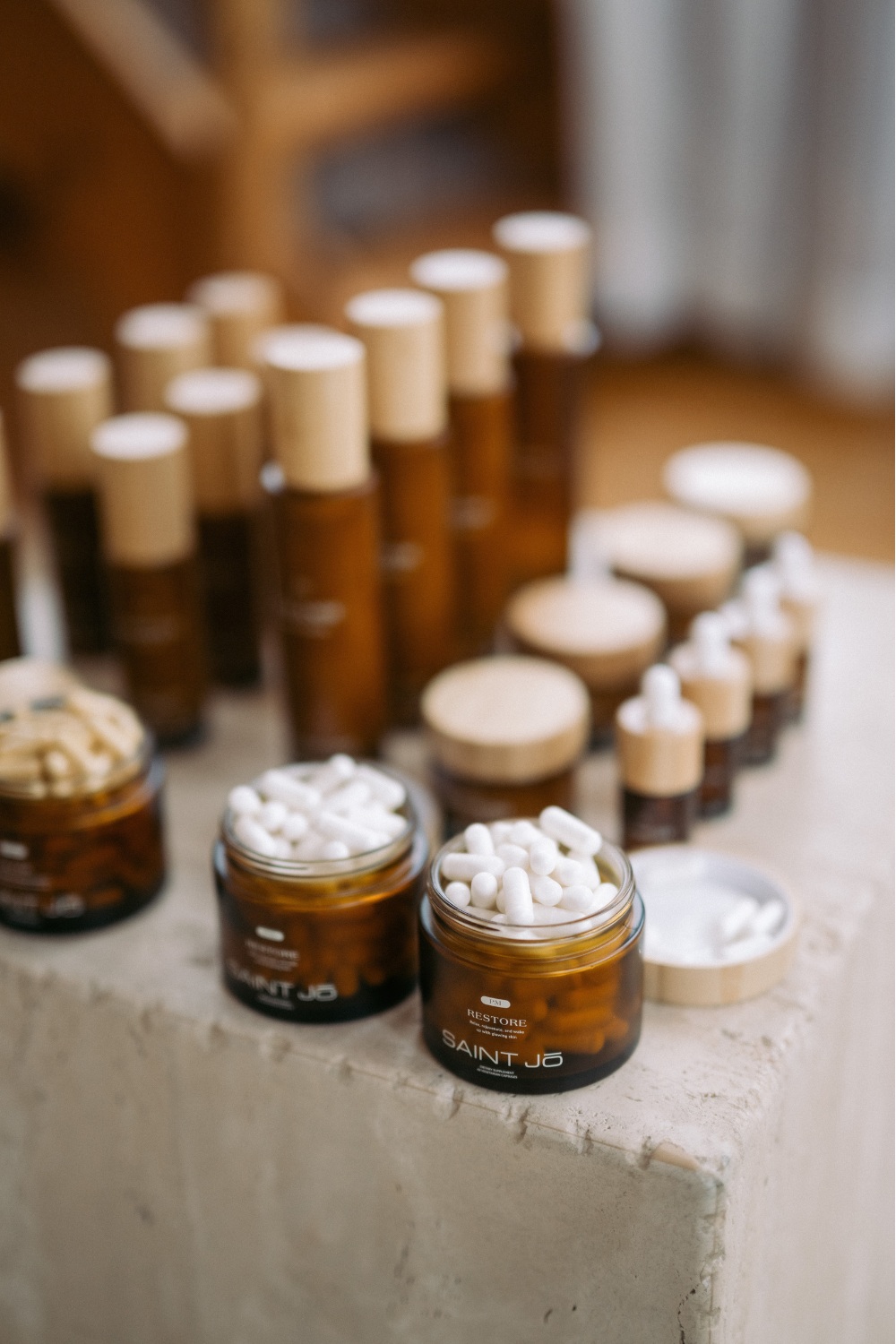 The Saint Jo skincare regime in full, lined up on stone plinth