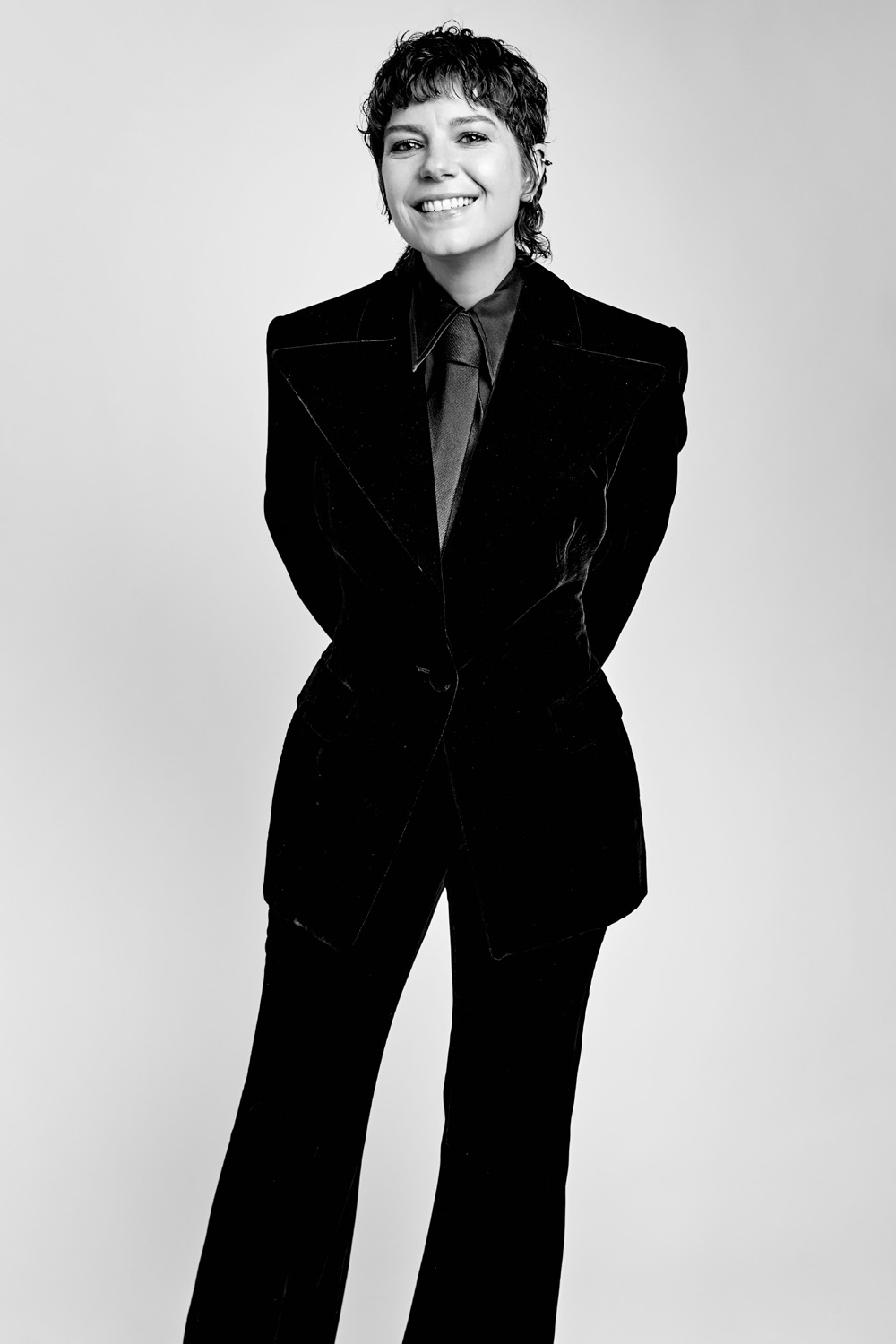 A black and white image of Aimée-Ffion Edwards in a black suit