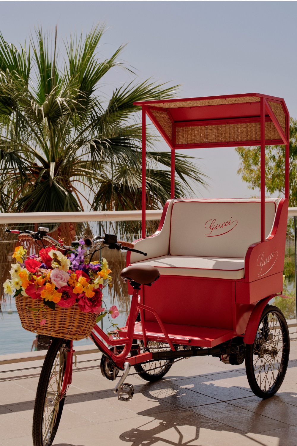 Red tuk tuk with floral basket | designer beach clubs