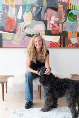 Lily King sitting on a chair with her dog