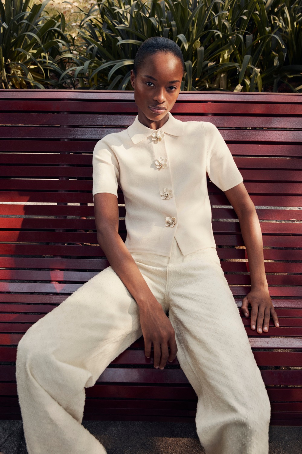 Woman sitting on bench wearing M&S cream set
