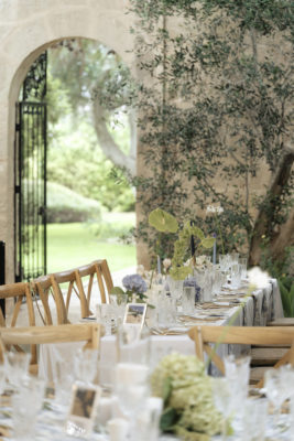 Betty was set for a wedding reception with a green plant and arched door.