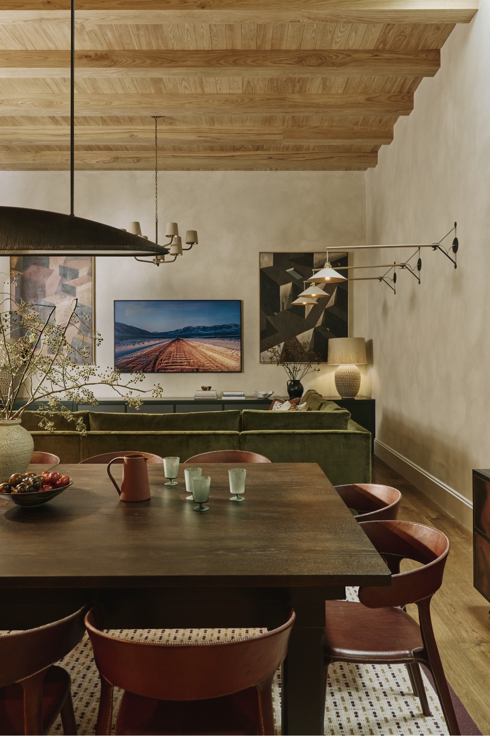 Dining table with green sofas in the background