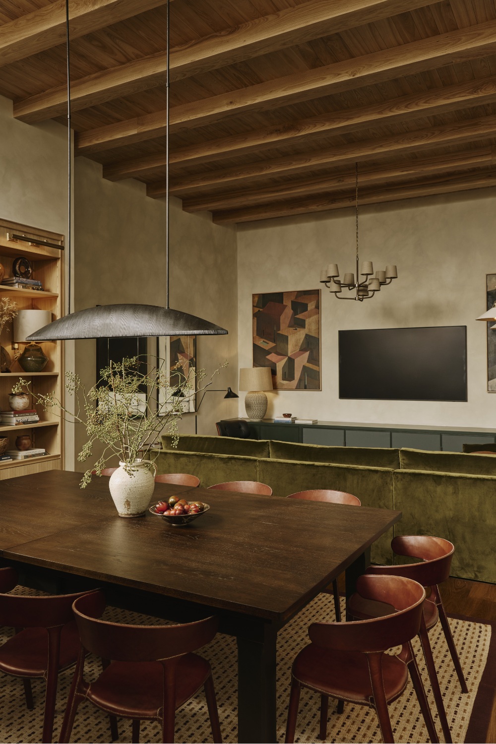 Dining table with green sofa and TV in background