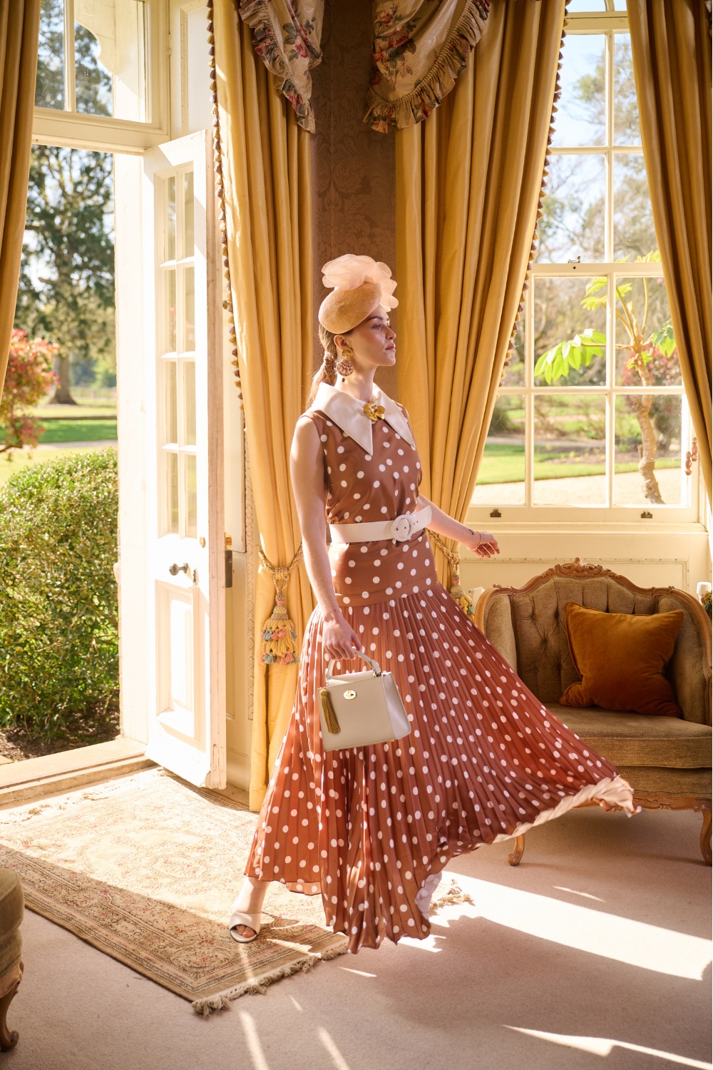 Woman wearing brown polka dot dress from VV Rouleaux SS26