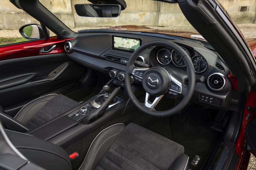 The front seats and steering wheel inside the MX-5 Roadster