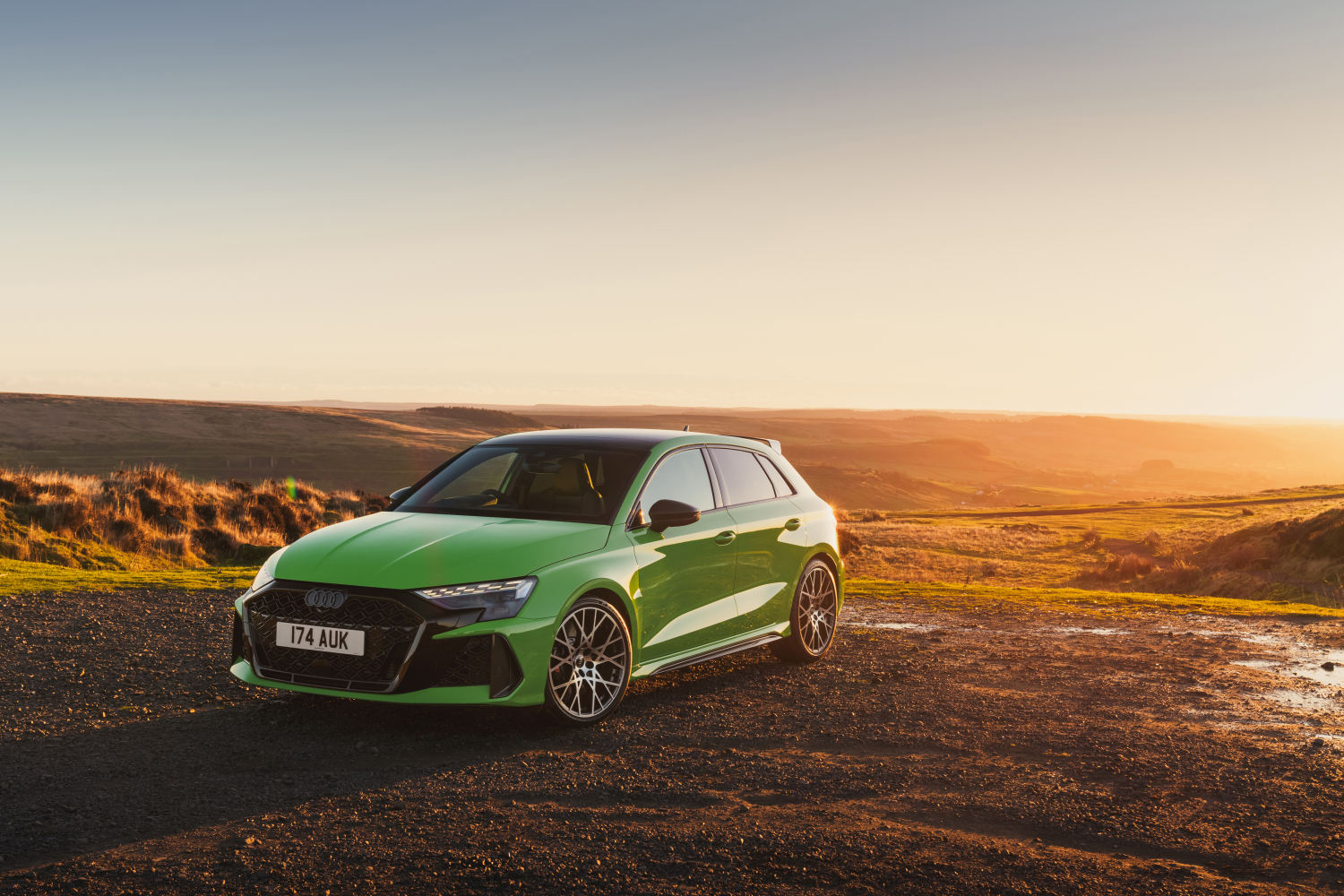 Green Audi RS 3 at dusk