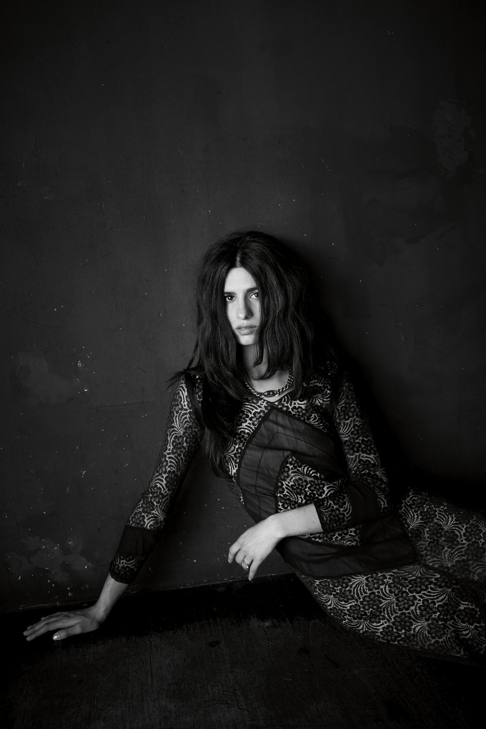 Black and white image of Hannah Khalique-Brown leaning against a wall