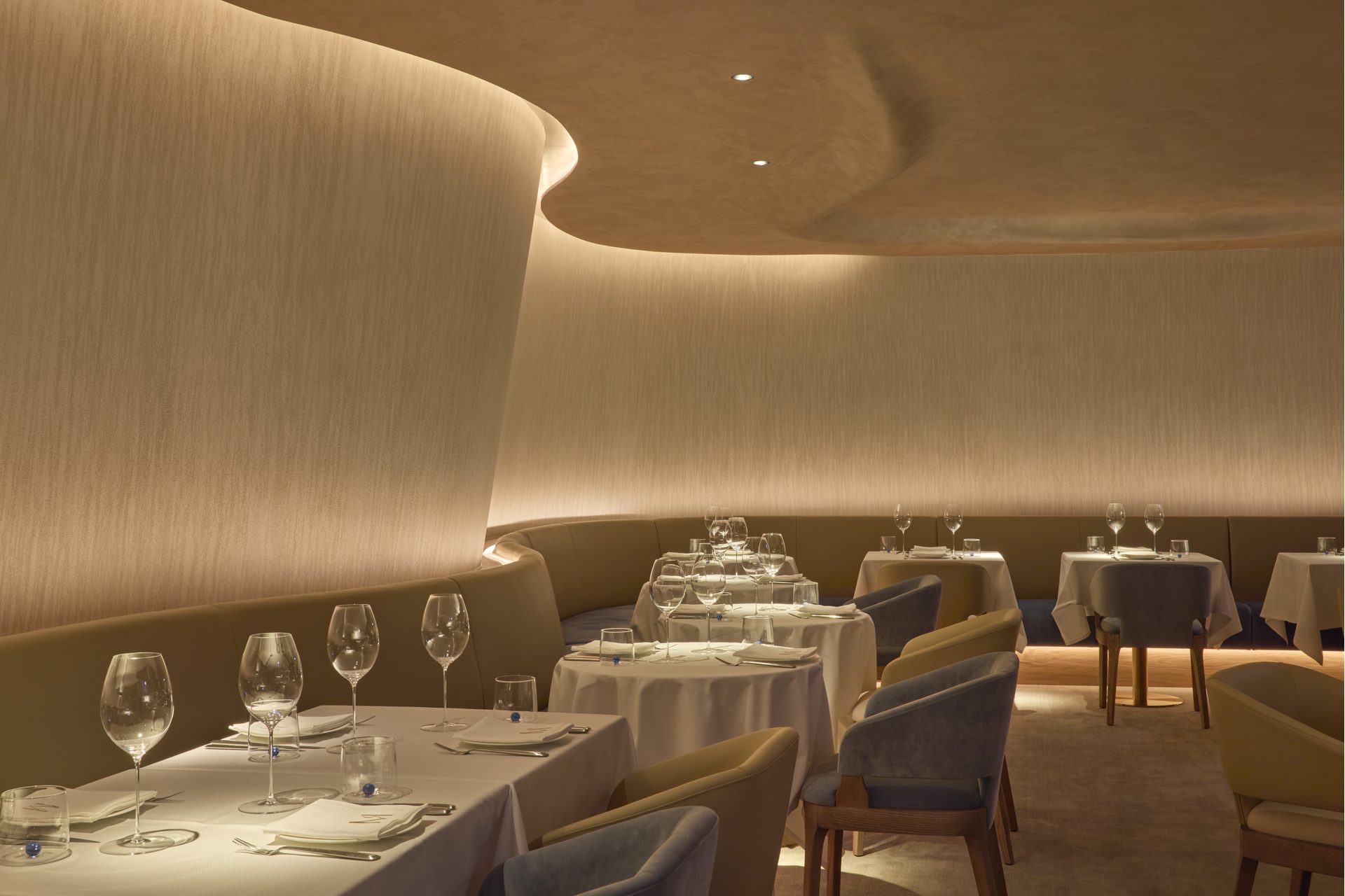A moody, modern dining room dressed in a neutral pallette
