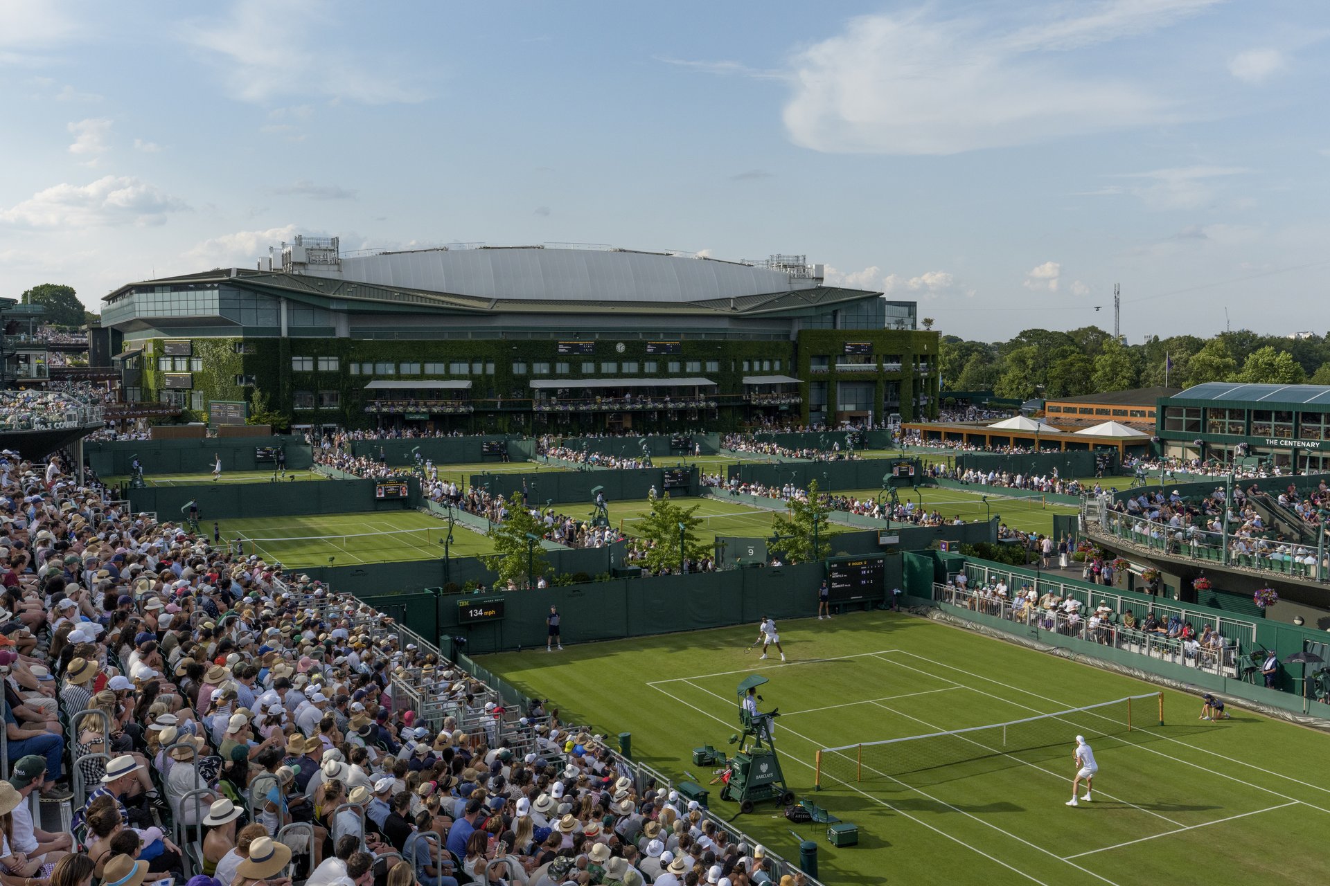 Aerial view across the Southern Courts towards Centre Court as Gael Monfils (FRA) plays against Ugo Humbert (FRA) in the first round match of the Gentlemen's Singles on Court 12 at The Championships 2025.
