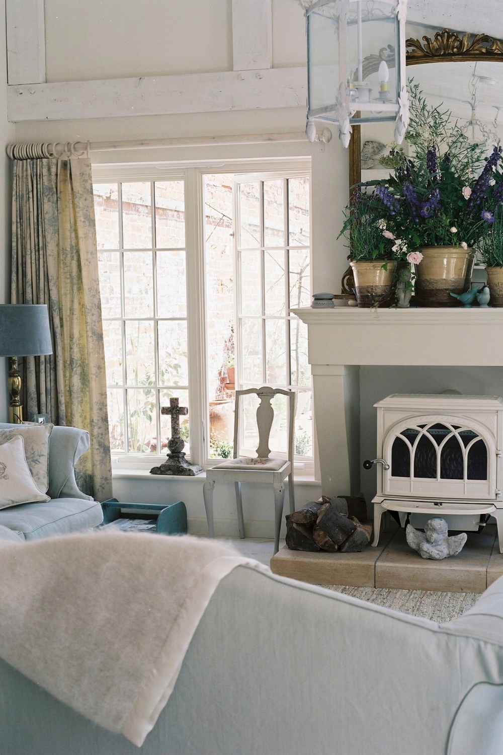 View over sofa into living room with log burner