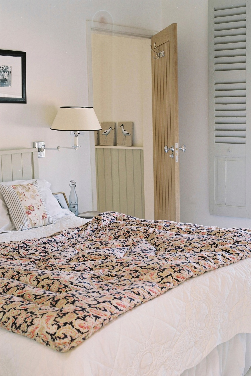 Master bedroom with printed throw on bed