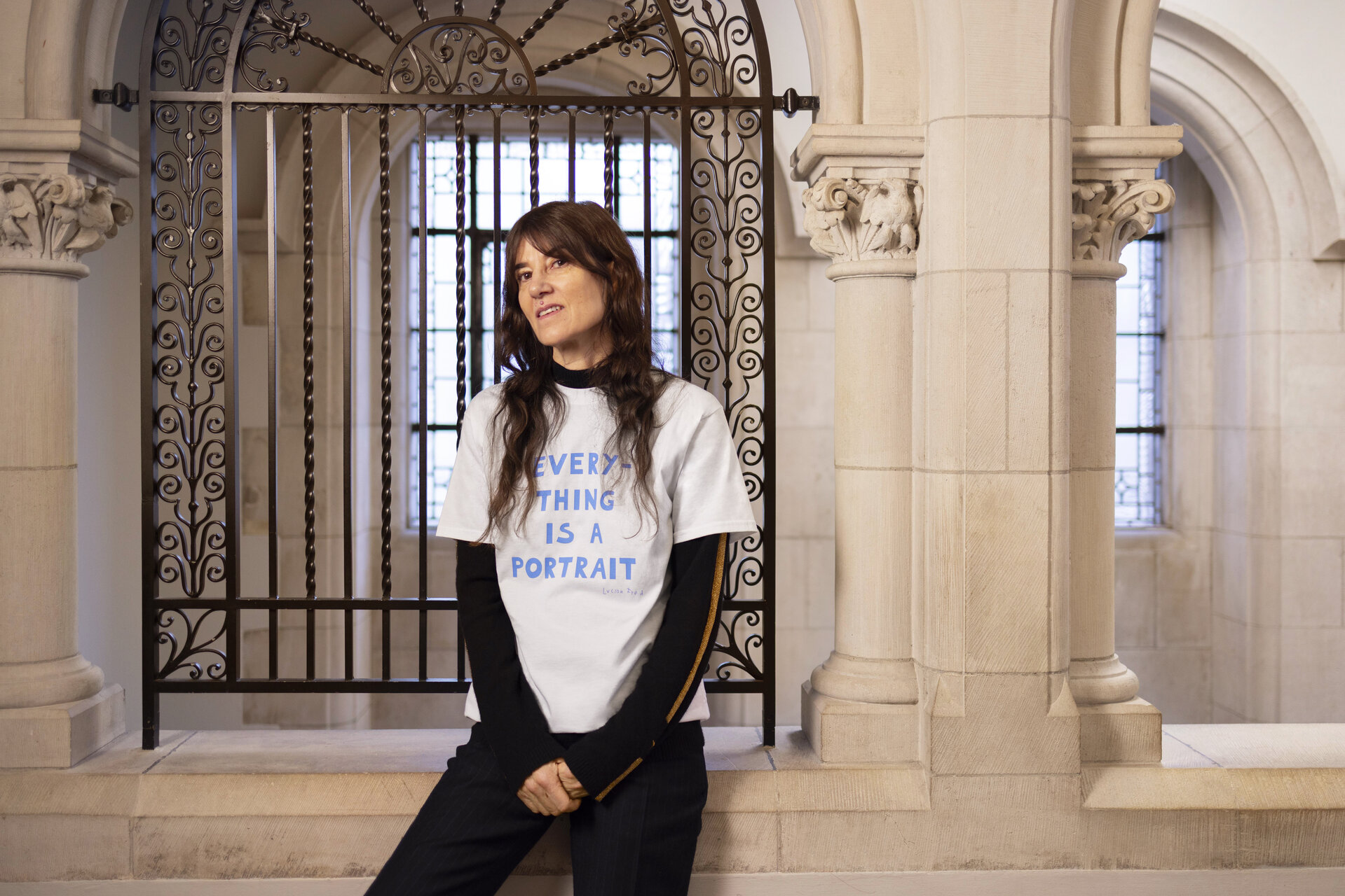 Bella wearing a white t-shirt reading 'everything is a portrait'