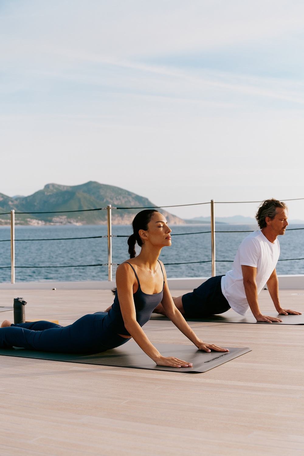 People doing yoga on boat