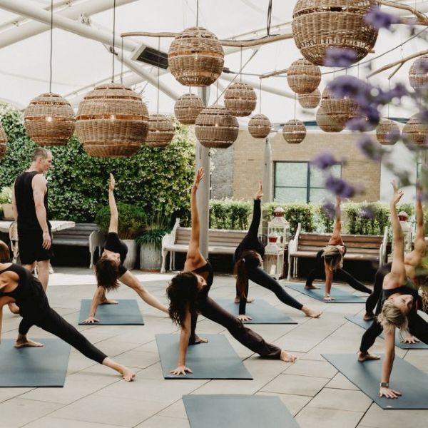 Women dressed in black doing yoga