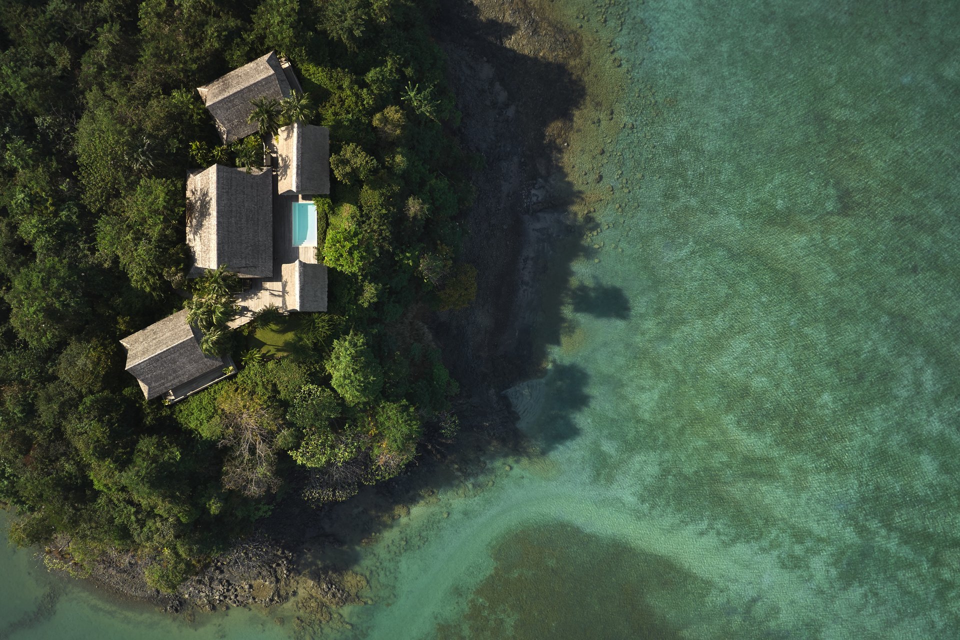 A villa surrounded by turquoise ocean