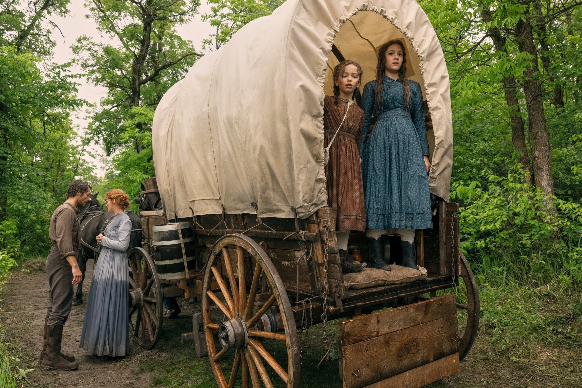 Luke Bracey as Charles Ingalls, Crosby Fitzgerald as Caroline Ingalls, Alice Halsey as Laura Ingalls & Skywalker Hughes as Mary Ingalls in Little House on the Prairie.