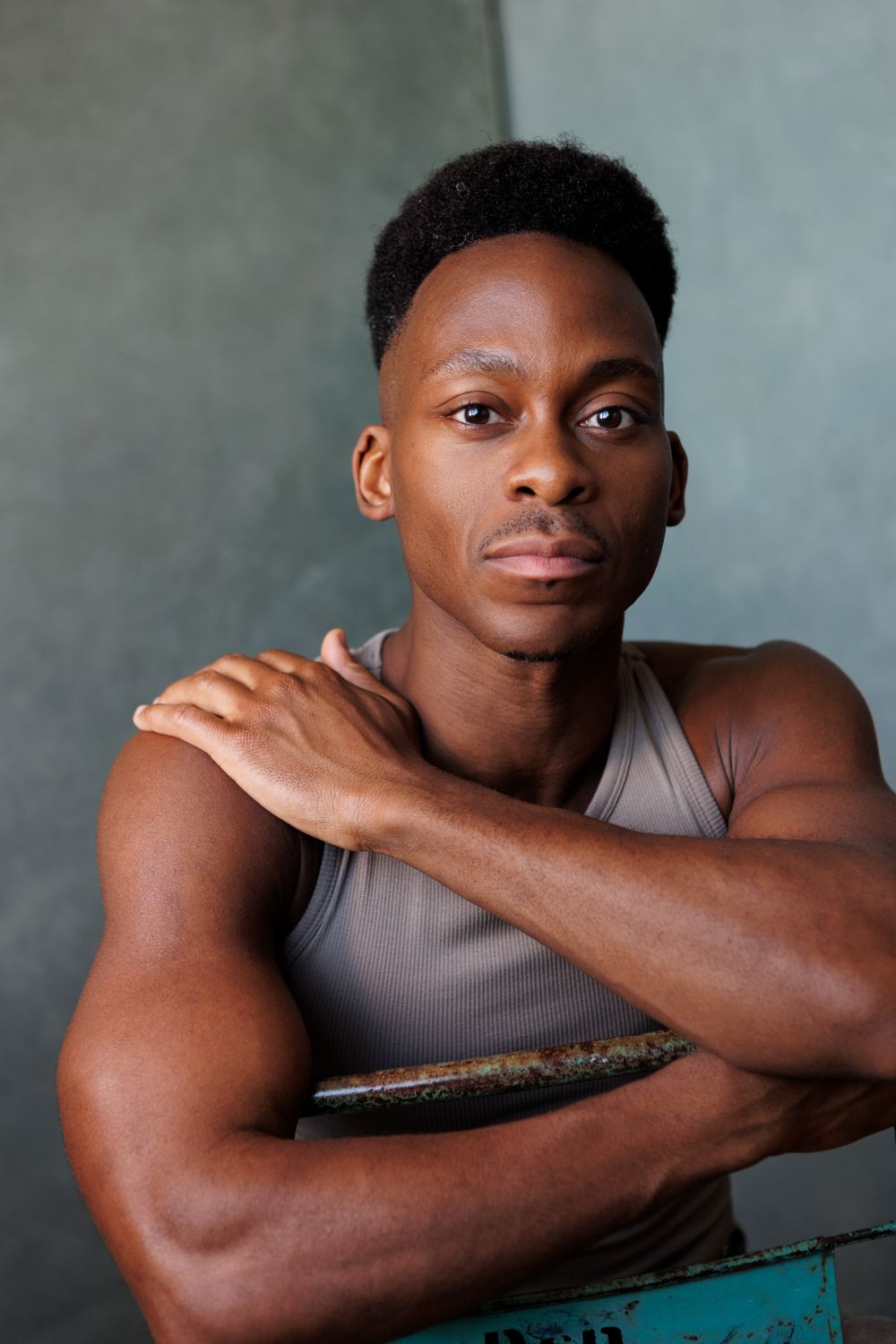 Actor Tyrone Huntley sitting backwards on a chair