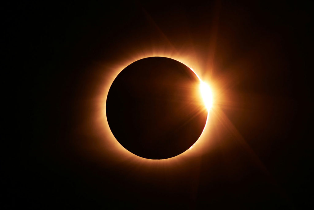 moon passing in front of the sun creating an eclipse