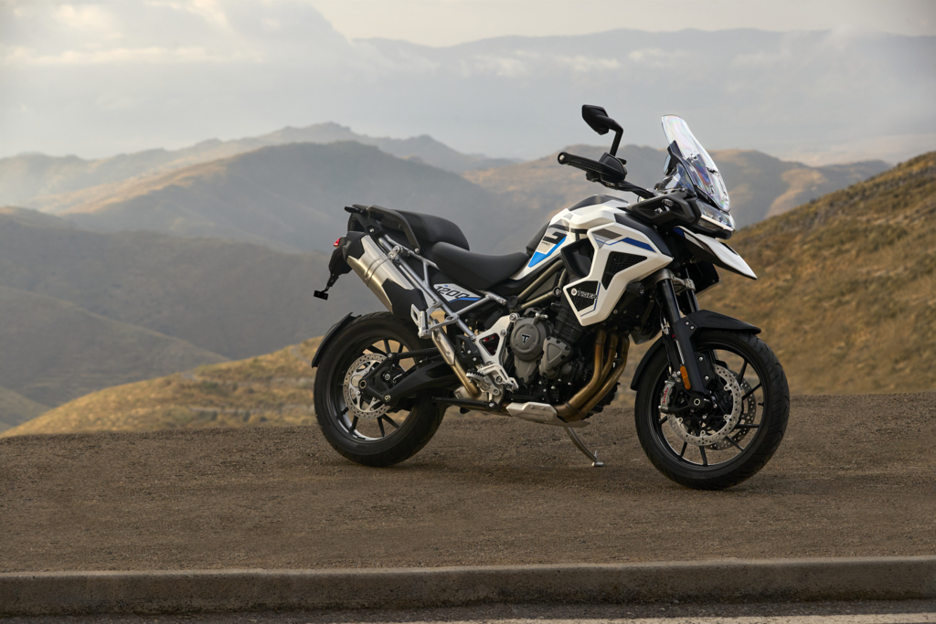The side of a motorbike backdropped by the desert