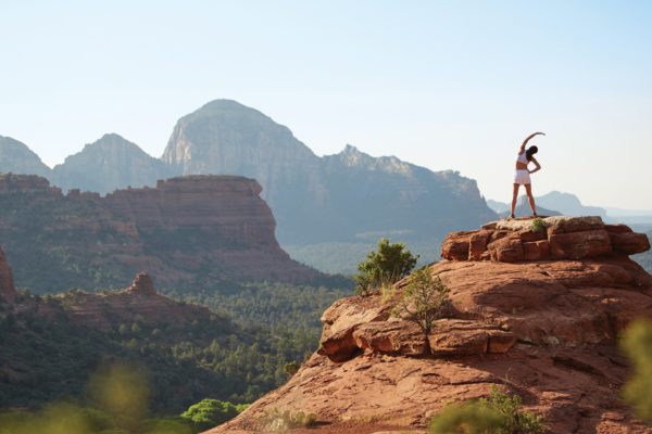 A woman stretching in a dramatic landscape