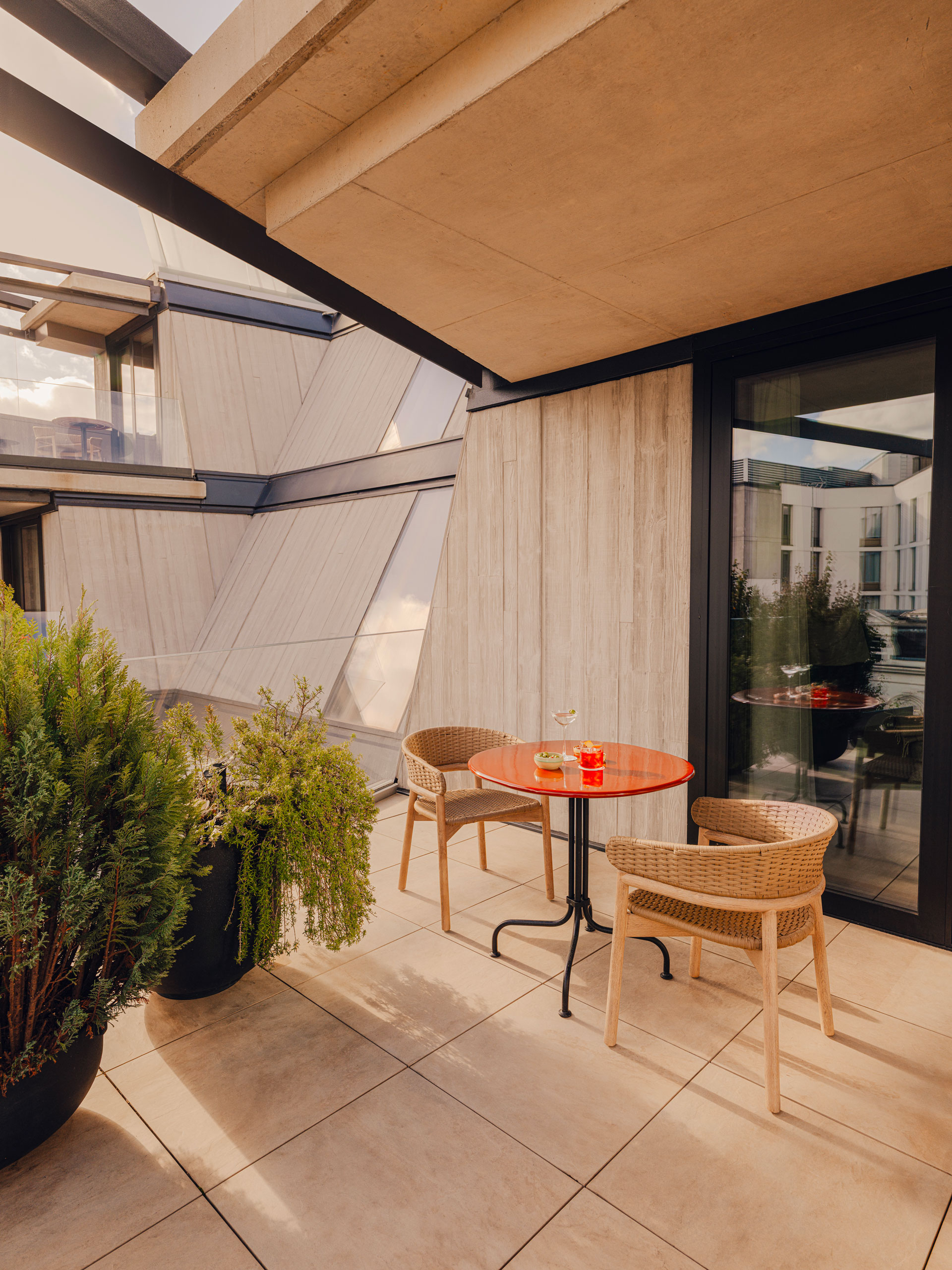 Two chairs on a stone balcony at Aethos London