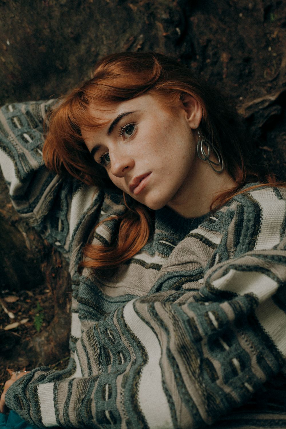 Close up of Aisling Sharkey resting on her arm against a tree