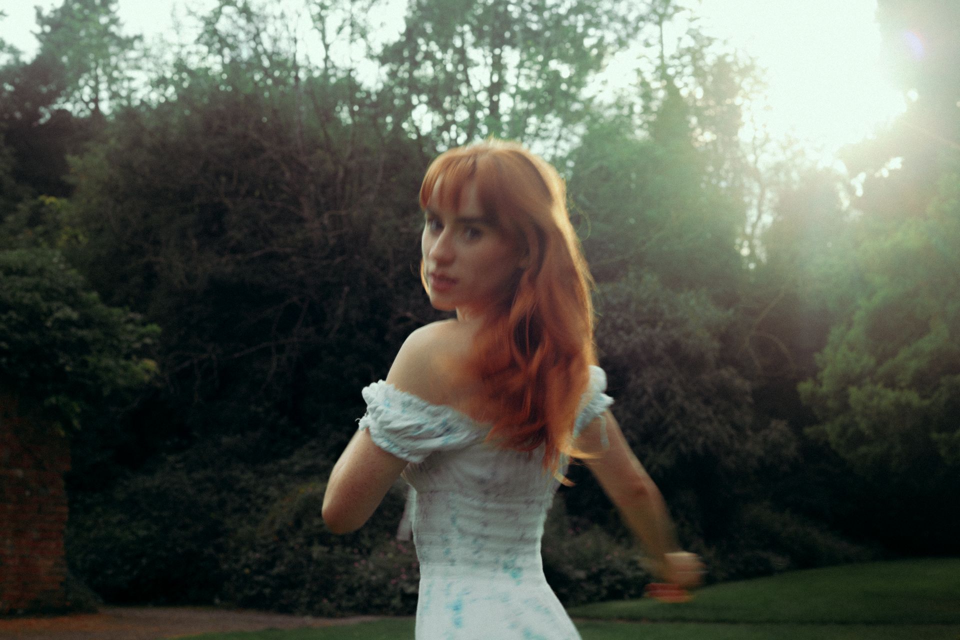 Aisling Sharkey in a dress among the trees, twirling in motion