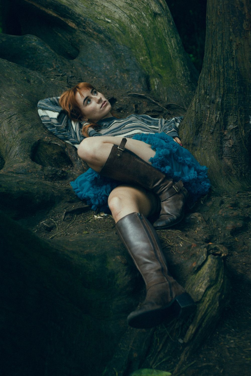 Aisling Sharkey lying between trees, looking pensively upwards